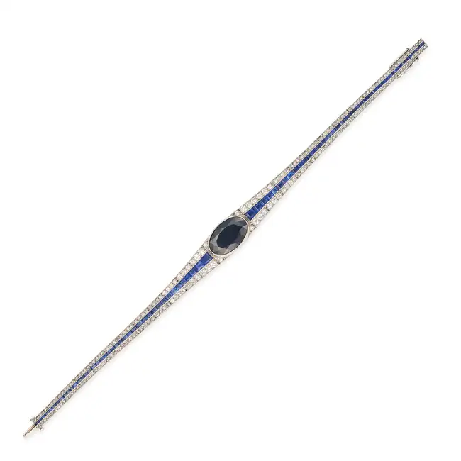 ATTR. MAUBOUSSIN, AN ART DECO SAPPHIRE AND DIAMOND BRACELET set with an oval cut sapphire of