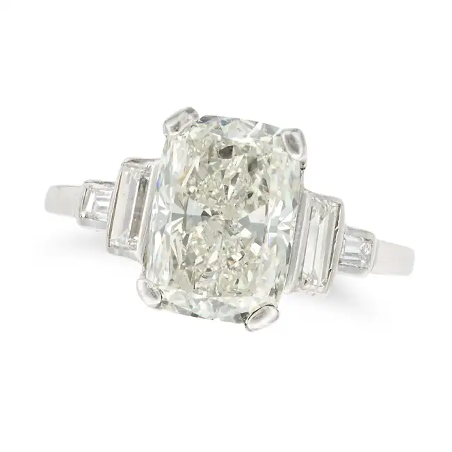 A DIAMOND RING set with a cushion cut diamond of 3.02 carats, the shoulders set with baguette cut