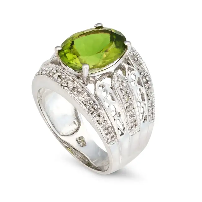 A PERIDOT AND DIAMOND RING AND EARRINGS SUITE the ring set with an oval cut peridot of approximately