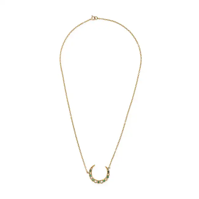 A PEARL AND EMERALD CRESCENT MOON NECKLACE the pendant designed as a crescent moon set with pearls