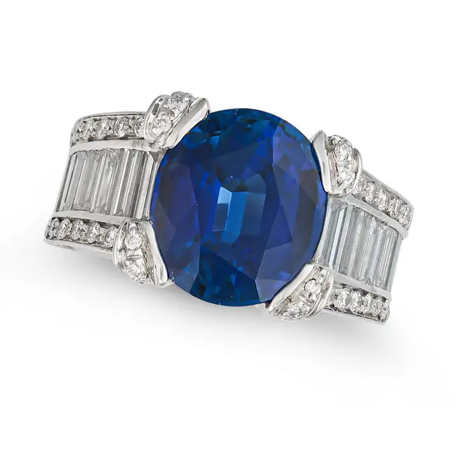 A FINE THAI SAPPHIRE AND DIAMOND DRESS RING in 18ct white gold, set with an oval cut sapphire of 7.