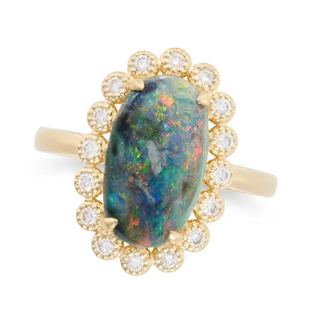 AN OPAL AND DIAMOND CLUSTER RING set with an oval cabochon opal of 2.40 carats within a cluster of