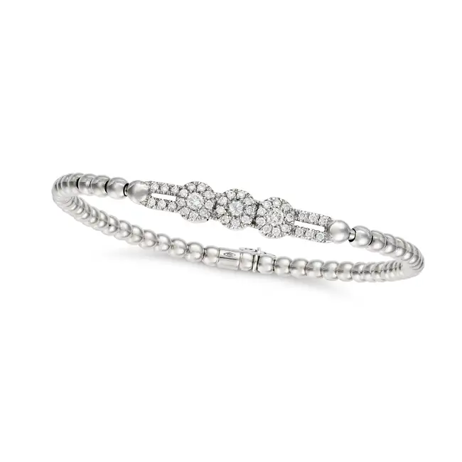 A DIAMOND MOVEABLE BRACELET in 18ct white gold, comprising three moveable clusters of round