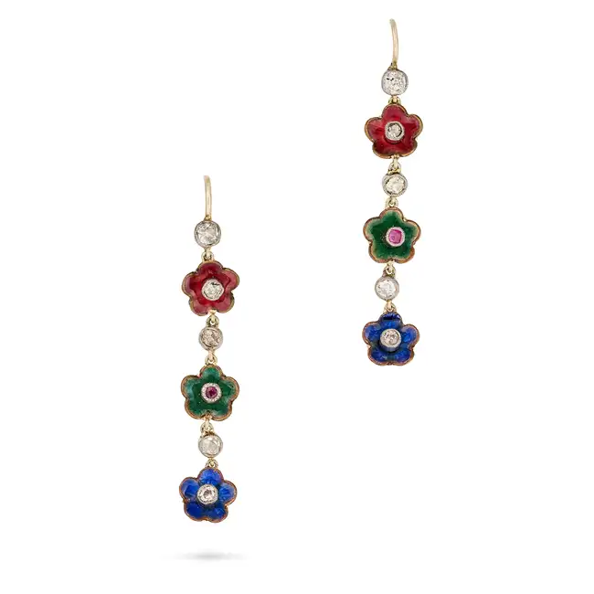 A PAIR OF DIAMOND, RUBY AND ENAMEL FLOWER DROP EARRINGS each comprising a row of three flowers set
