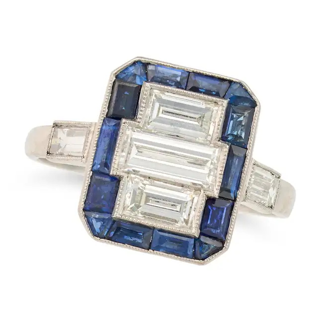 AN ART DECO DIAMOND AND SAPPHIRE DRESS RING set with three baguette cut diamonds within a border