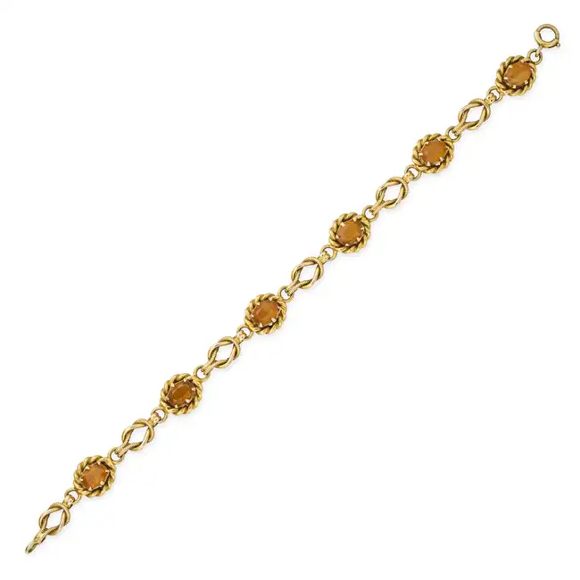 A VINTAGE CITRINE BRACELET in 9ct yellow gold, comprising six oval cut citrines within twisted