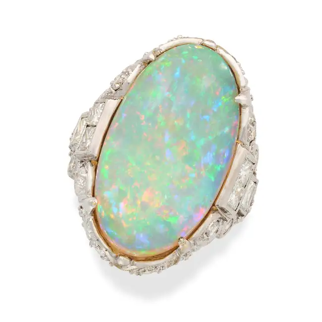A VINTAGE OPAL AND DIAMOND DRESS RING set with an oval cabochon opal of approximately 11.34