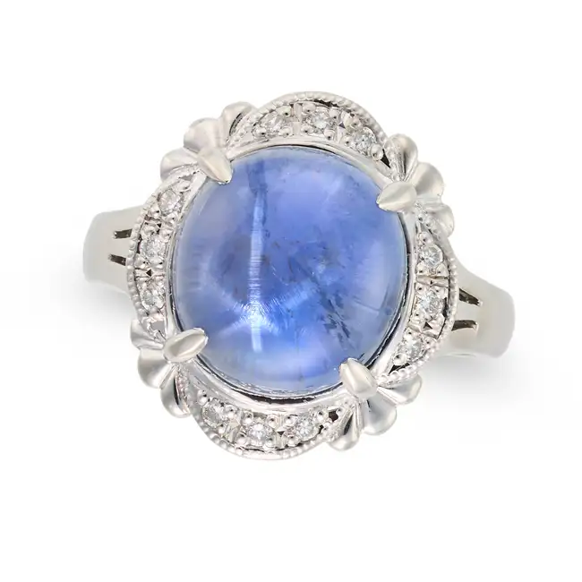 NO RESERVE - A 7.66 CARAT STAR SAPPHIRE AND DIAMOND RING set with an oval cabochon star sapphire