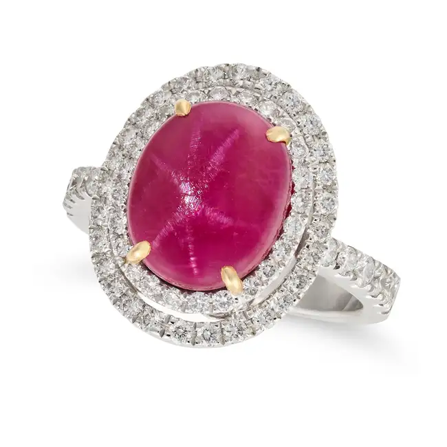 NO RESERVE - A 5.01 CARAT STAR RUBY AND DIAMOND DRESS RING set with an oval cabochon star ruby of