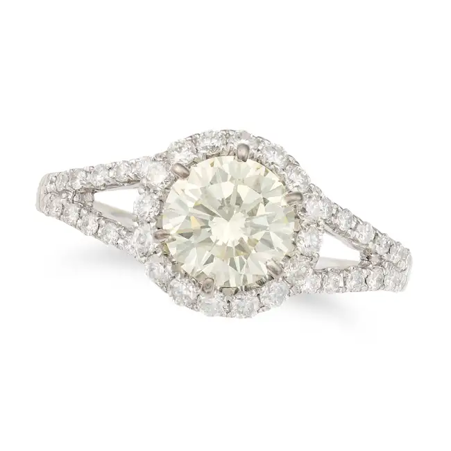 A DIAMOND DRESS RING set with a round brilliant cut diamond of approximately 1.20 carats, within a