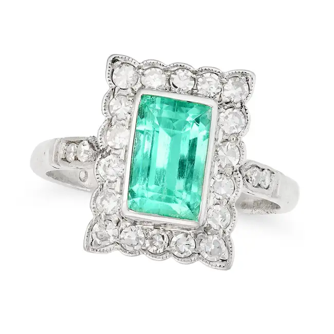 AN EMERALD AND DIAMOND DRESS RING set with a rectangular step cut emerald of approximately 1.61
