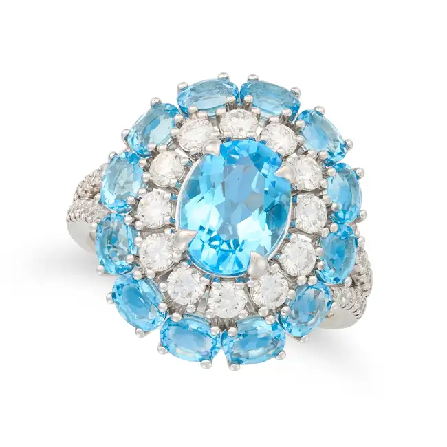 NO RESERVE - A BLUE TOPAZ AND DIAMOND CLUSTER RING in 18ct white gold, set with an oval cut blue