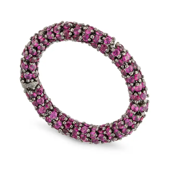 DEMEGLIO, A RUBY FULL ETERNITY RING in 18ct gold, pave set all around with round cut rubies