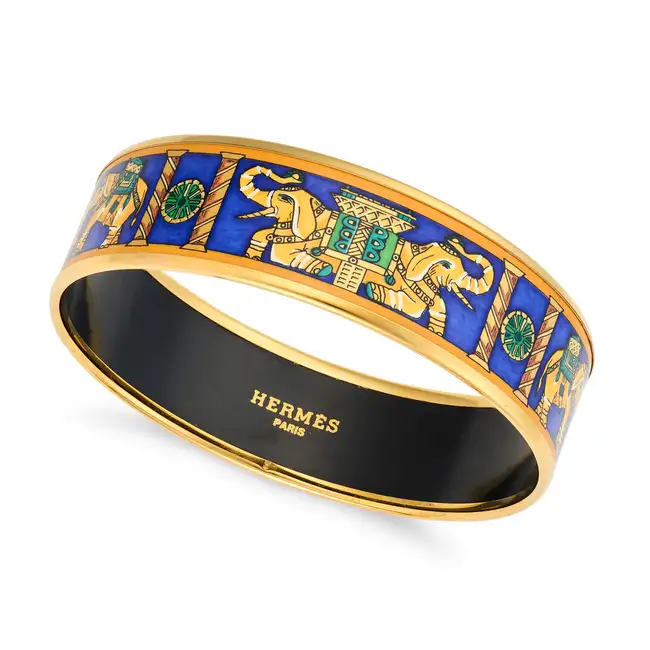 NO RESERVE - HERMES, AN ENAMEL ELEPHANT BANGLE decorated all around with elephants and columns,