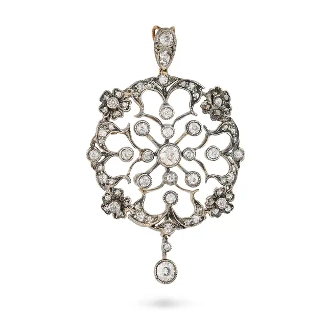 AN ANTIQUE DIAMOND PENDANT in yellow gold and silver, the open work pendant in foliate design, set