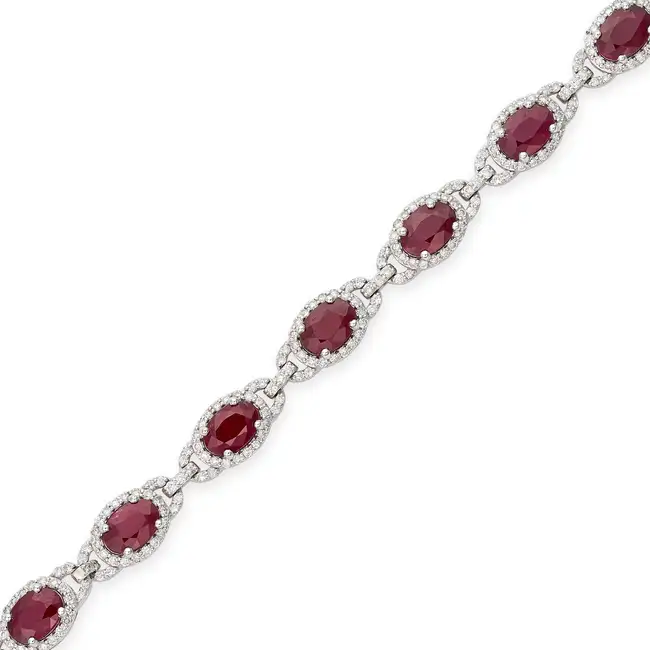 OSCAR FRIEDMAN, A RUBY AND DIAMOND BRACELET set with a row of oval cut rubies in borders of round