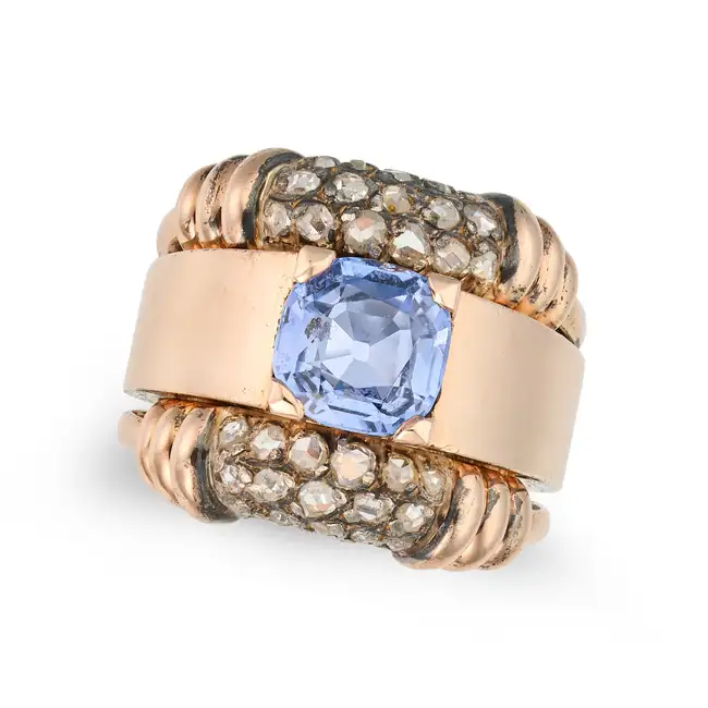 A RETRO SAPPHIRE AND DIAMOND DRESS RING set with a cushion cut sapphire of approximately 3.01