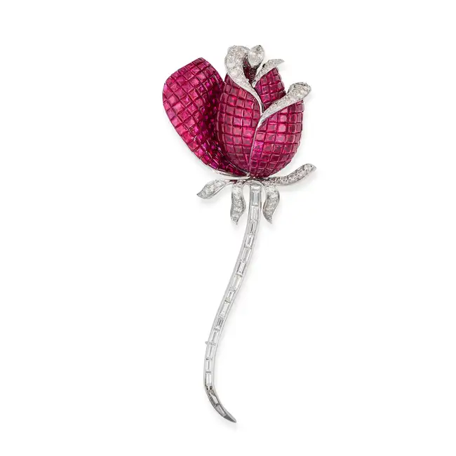 AN EXQUISITE RUBY AND DIAMOND FLOWER CLIP BROOCH designed as a flower invisibly set with calibre cut