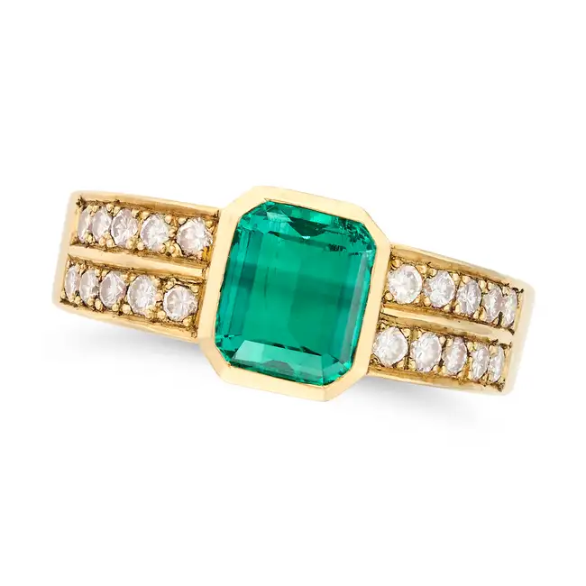 A COLOMBIAN EMERALD AND DIAMOND RING set with an octagonal step cut emerald of approximately 1.80