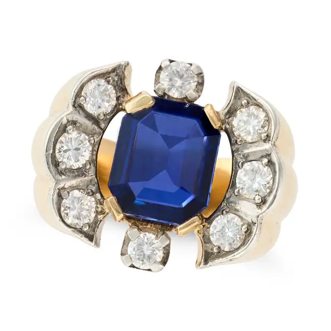 A RETRO SAPPHIRE AND DIAMOND RING in 18ct yellow gold, set with an octagonal step cut sapphire of