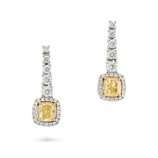 A PAIR OF FANCY YELLOW DIAMOND DROP EARRINGS in 18ct white gold, each suspending a cushion cut