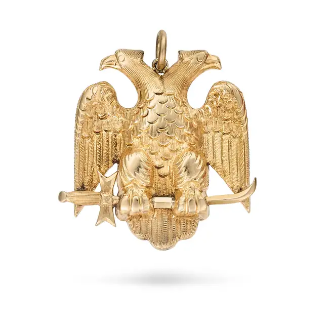 A DOUBLE HEADED EAGLE PENDANT designed as a double headed eagle holding a sword, no assay marks, 2.