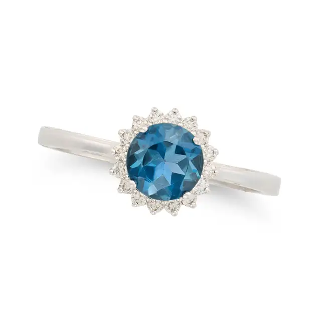 NO RESERVE - A BLUE TOPAZ AND DIAMOND CLUSTER RING in 18ct white gold, set with a round cut blue