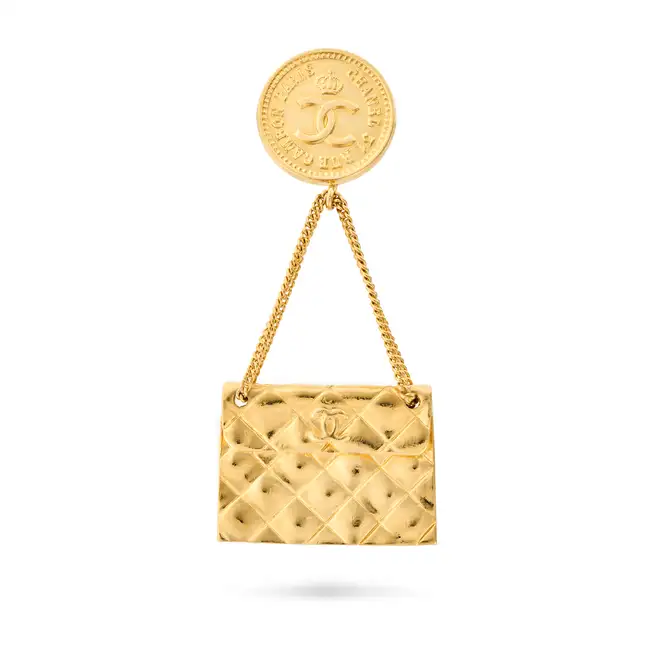 CHANEL, A 31 RUE CAMBON PARIS BAG BROOCH comprising a circular medallion engraved 31 Rue Cambon
