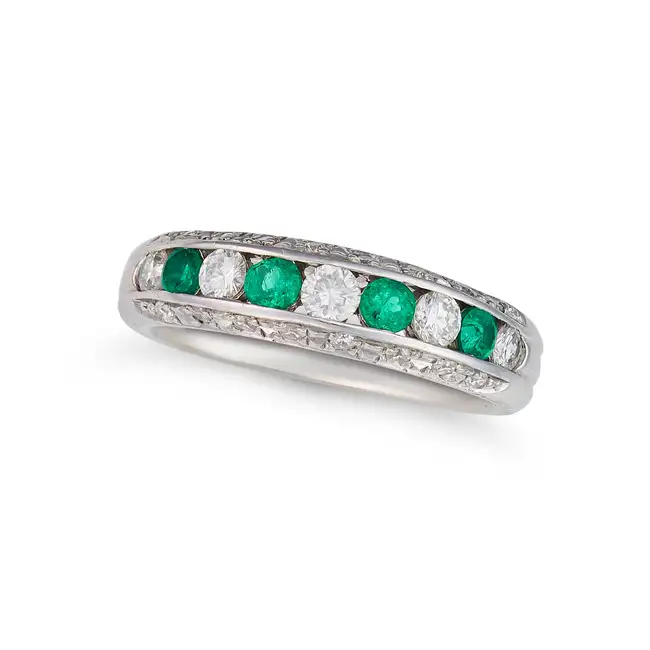 AN EMERALD AND DIAMOND HALF ETERNITY RING set with a row of alternating round cut emeralds and round