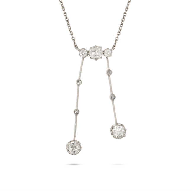 AN ANTIQUE DIAMOND NEGLIGEE NECKLACE in platinum, the pendant set with three old cut diamonds suspending two drops set with rose and old cut diamonds, the diamonds all totalling 1.5-1.7 carats, no assay marks, pendant 4.0cm, chain 44.0cm, 6.8g. 