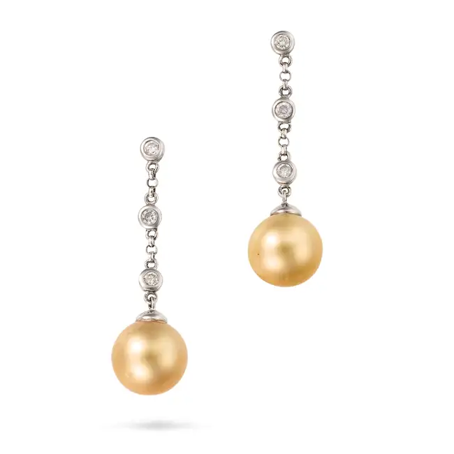 A PAIR OF GOLDEN PEARL AND DIAMOND DROP EARRINGS in 18ct white gold, comprising a trace chain