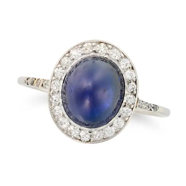 A FINE ANTIQUE SAPPHIRE AND DIAMOND DRESS RING, EARLY 20TH CENTURY set with an oval cabochon