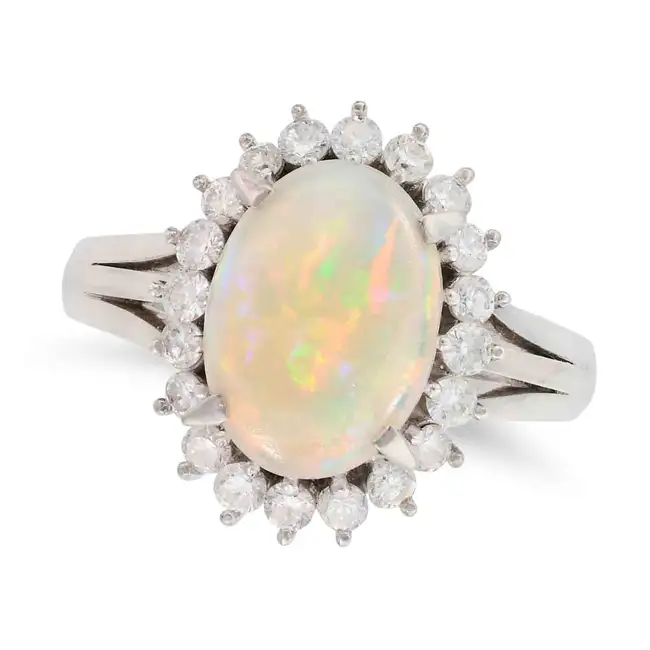 AN OPAL AND DIAMOND CLUSTER RING set with an oval cabochon opal of 1.71 carats, accented by round