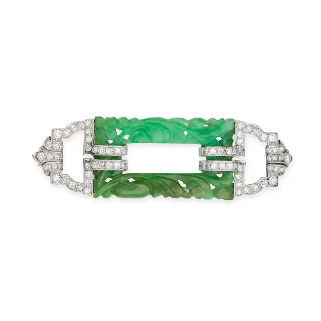 A FINE ART DECO JADEITE JADE AND DIAMOND BROOCH set with a jadeite jade plaque carved with foliate