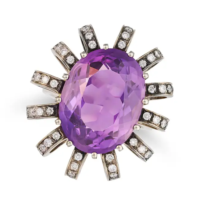 AN AMETHYST AND DIAMOND DRESS RING set with an oval cut amethyst of approximately 12.85 carats,