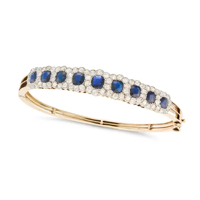 AN ANTIQUE SAPPHIRE AND DIAMOND CLUSTER BANGLE the hinged bangle set with a row of graduating