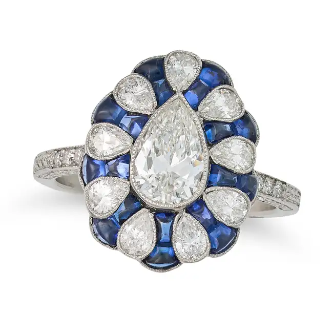 A FINE DIAMOND AND SAPPHIRE DRESS RING set with an old pear cut diamond of approximately 0.74