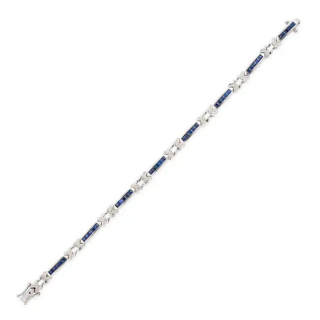A SAPPHIRE AND DIAMOND BRACELET comprising links set with square step cut sapphires, accented by