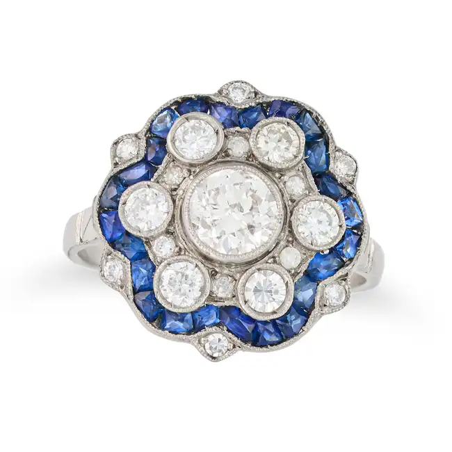 A DIAMOND AND SAPPHIRE DRESS RING set with an old cut diamond of approximately 0.48 carats, accented