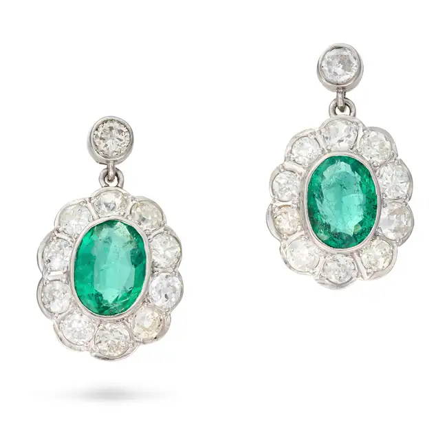 A PAIR OF FINE EMERALD AND DIAMOND CLUSTER DROP EARRINGS each suspending an oval cut emerald in a