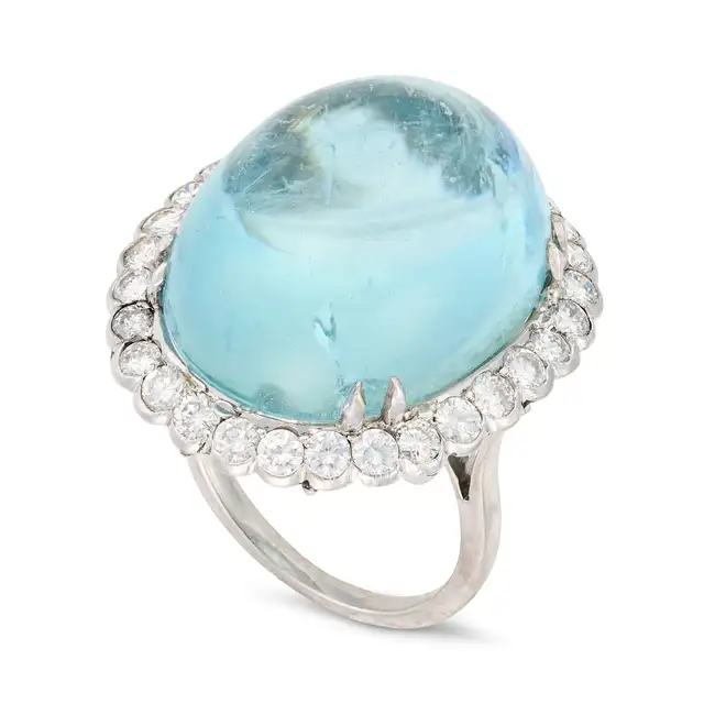 A LARGE AQUAMARINE AND DIAMOND DRESS RING set with an oval cabochon aquamarine of approximately 29.