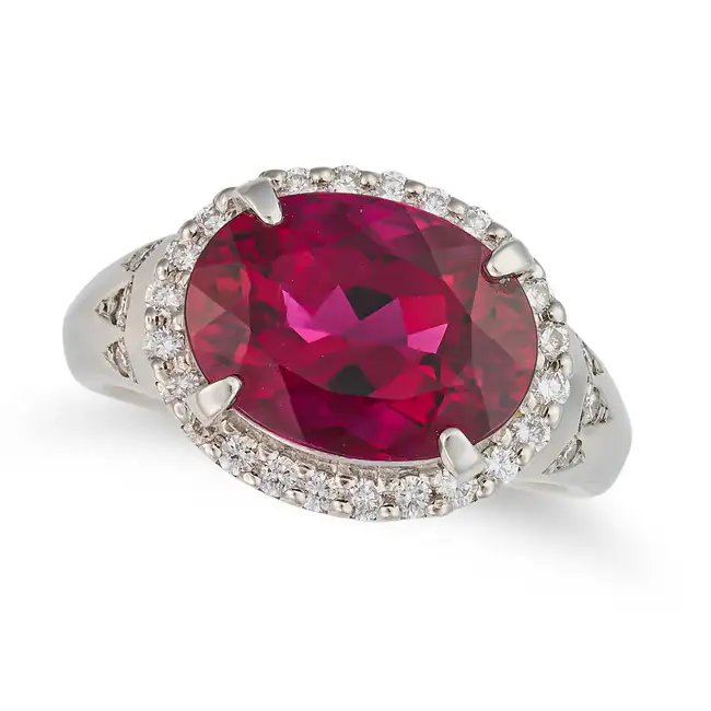 A RUBELLITE TOURMALINE AND DIAMOND DRESS RING set with an oval cut rubellite tourmaline of 5.09