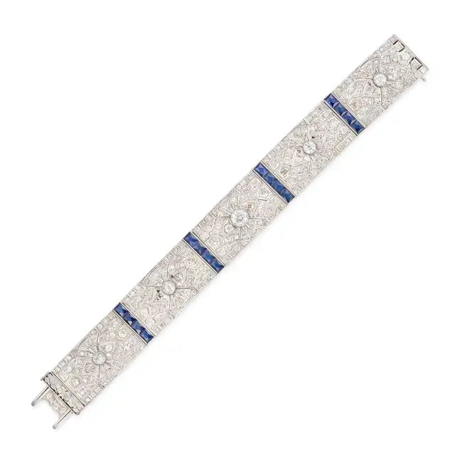 AN ART DECO SAPPHIRE AND DIAMOND STRAP BRACELET comprising a row of pierced geometric links set with