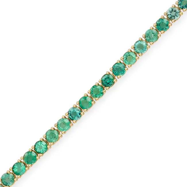 A 6.98 CARAT EMERALD LINE BRACELET comprising a row of round cut emerald totalling 6.98 carats,