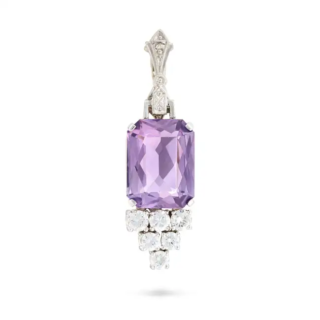 AN AMETHYST AND DIAMOND PENDANT set with an octagonal mixed cut amethyst, accented by round