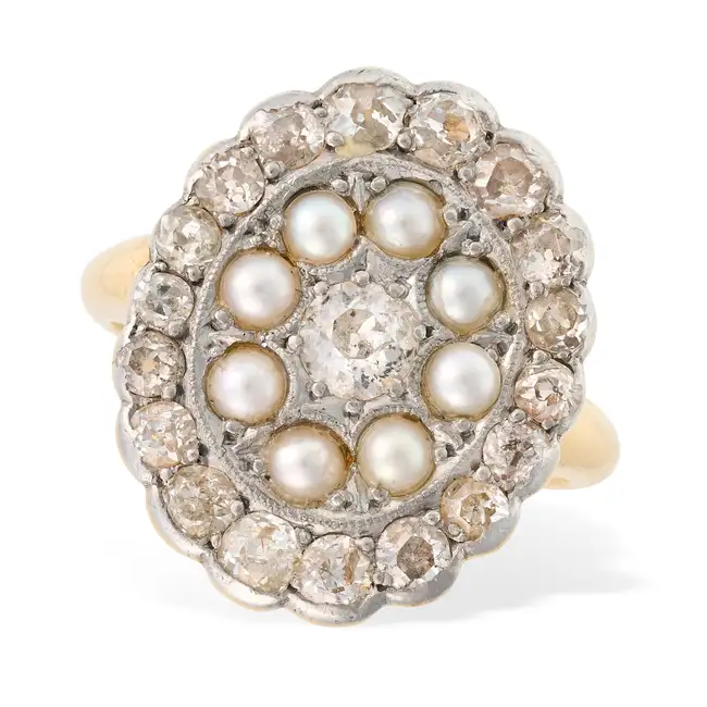 AN ANTIQUE DIAMOND AND PEARL CLUSTER RING set with an old cut diamond within a double cluster of