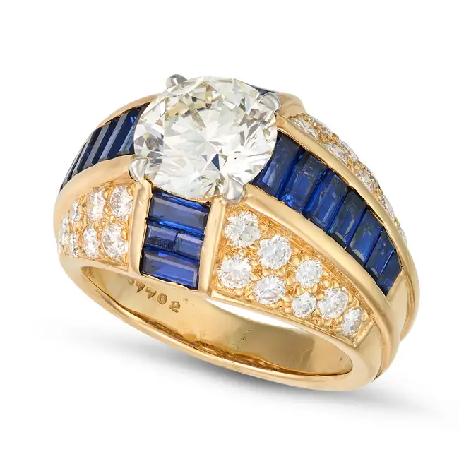 OSCAR HEYMAN, A FINE DIAMOND AND SAPPHIRE DRESS RING set with a round brilliant cut diamond of 2.