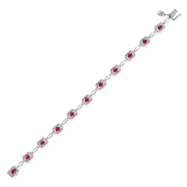 A RUBY AND DIAMOND BRACELET comprising a row of fancy links, set with oval cut rubies accented by