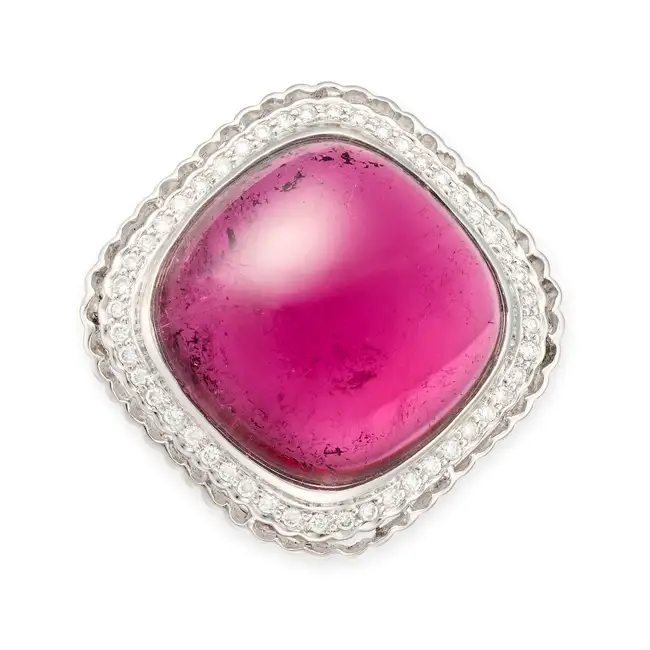 A RUBELLITE TOURMALINE AND DIAMOND BROOCH / PENDANT set with a cabochon rubellite tourmaline of