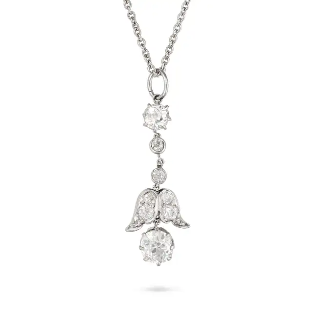 A DIAMOND PENDANT NECKLACE the pendant comprising a row of old cut diamonds, suspending a foliate